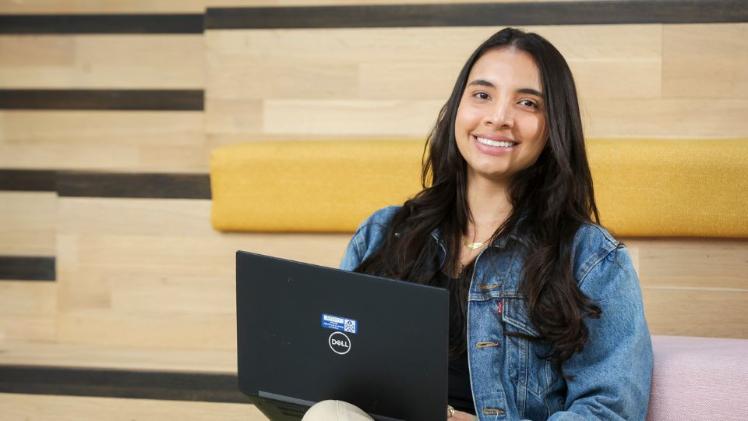 student sitting on staircase with laptop