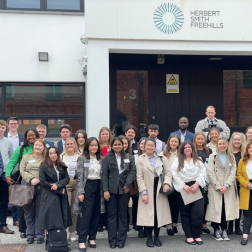 students on spotlight on law tour standing outside Herbert Smith Freehills