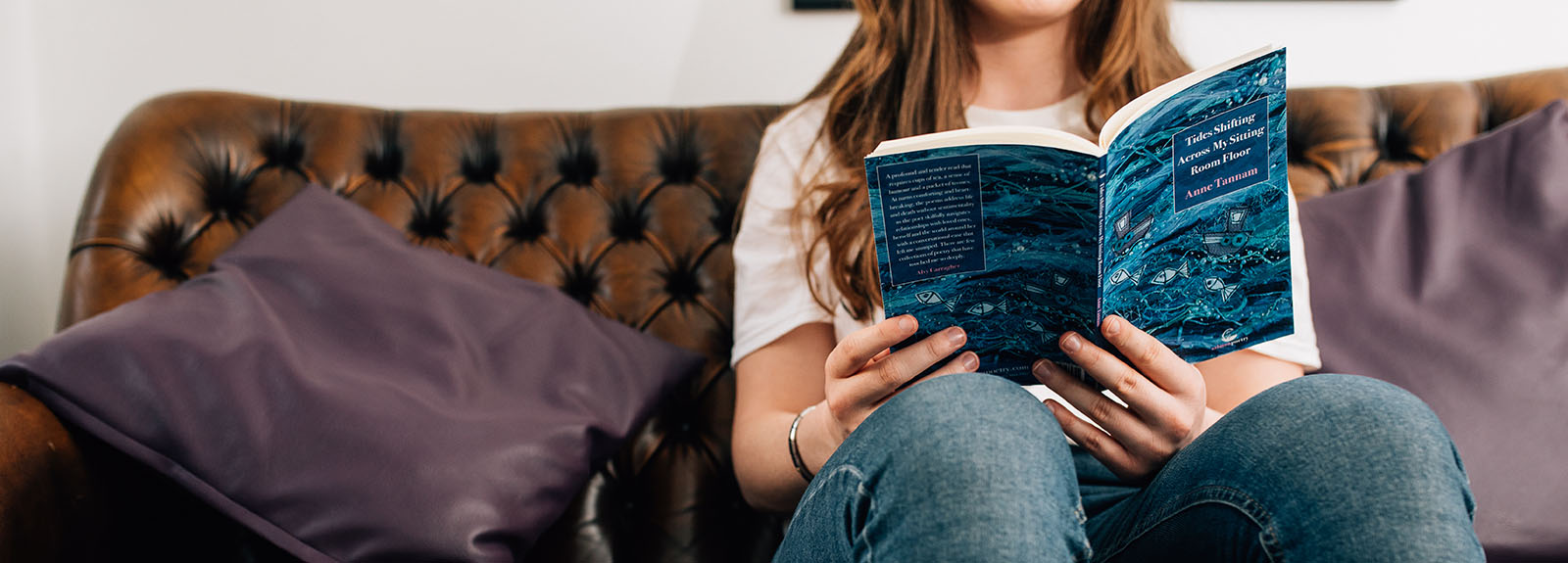 Student reading on a sofa