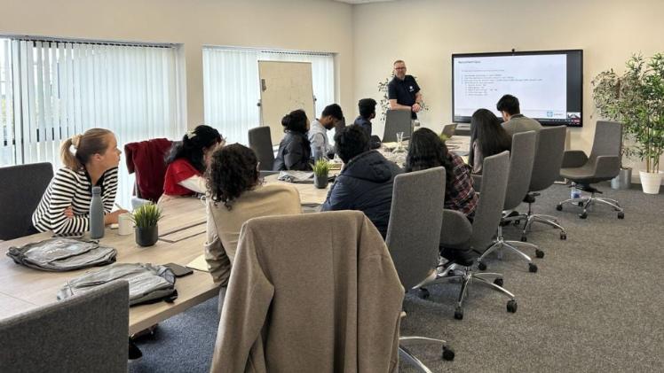 students at an employer premises listening to a talk