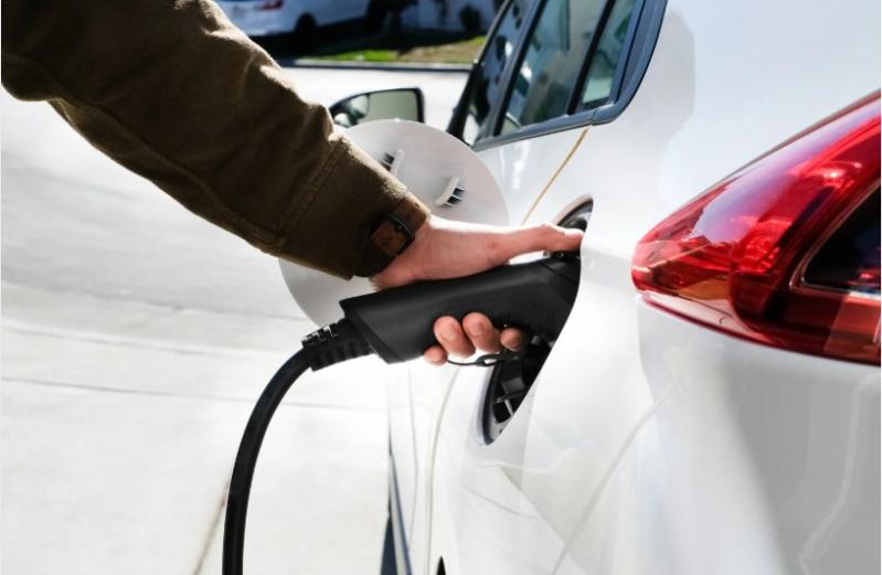 image of a man's hand filling up a car with fuel