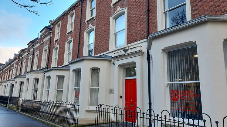 red brick terrace houses with bay windows and painted ground floor walls