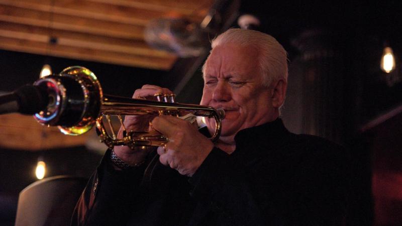 Person playing a trumpet.
