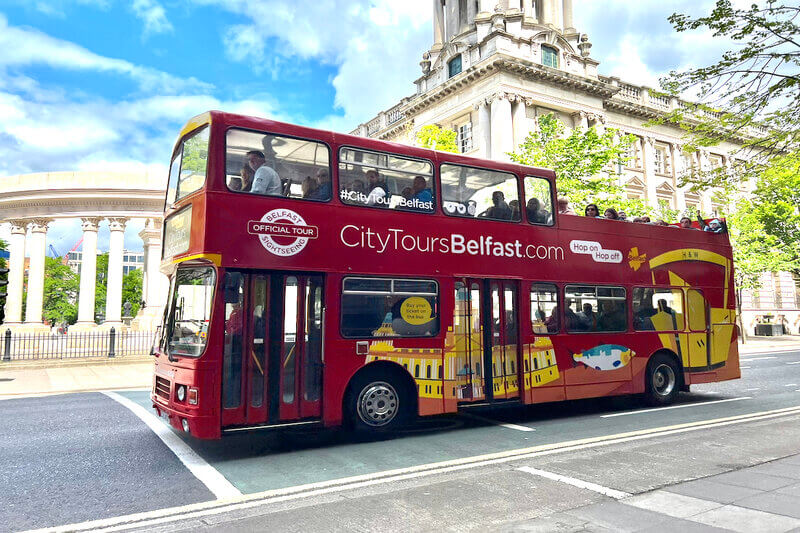 A City Tours Belfast Bus driving through the City Centre.