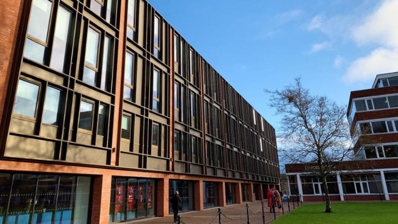 three storey modern building with frontage in glass and metal