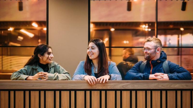 three student standing in a row