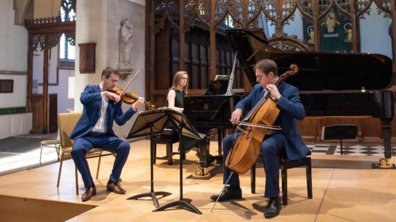Three musicians playing instruments