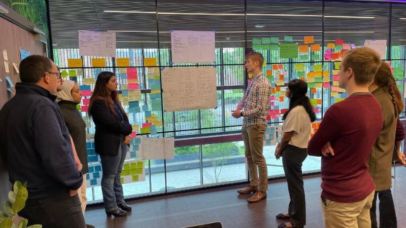 student standing chatting during the last real-world consultancy programme