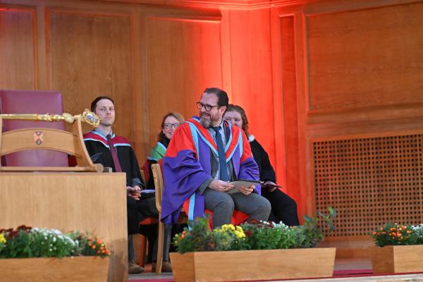 14. Dr Cathal McManus joyfully begins the roll call for the graduates to receive their certificates.