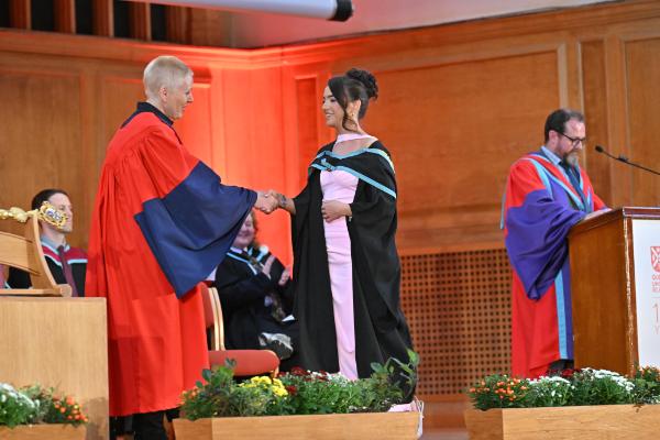 16. An R-City graduate is recognised for their dedication and success,