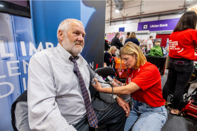 An attendee of the Balmoral show has his blood pressure taken by an academic