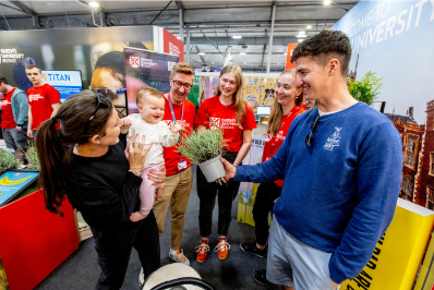 A baby with their parents engage with the Sustainability Team at the Balmoral Show 2024