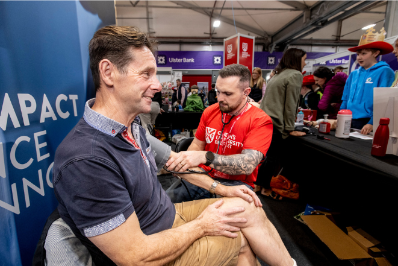 An attendee of the Balmoral show has his blood pressure taken by an academic