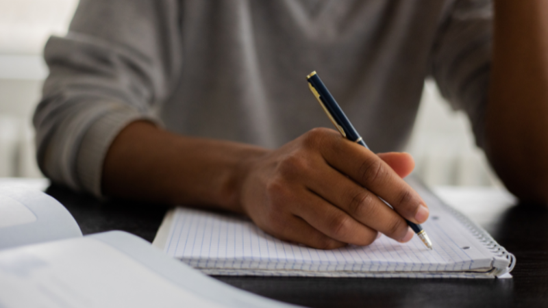 Person writing on paper