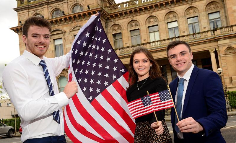 Students wave american flags