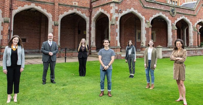 scholars stand apart on Queen's lawn