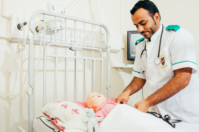 Male nurse works on a dummy patient