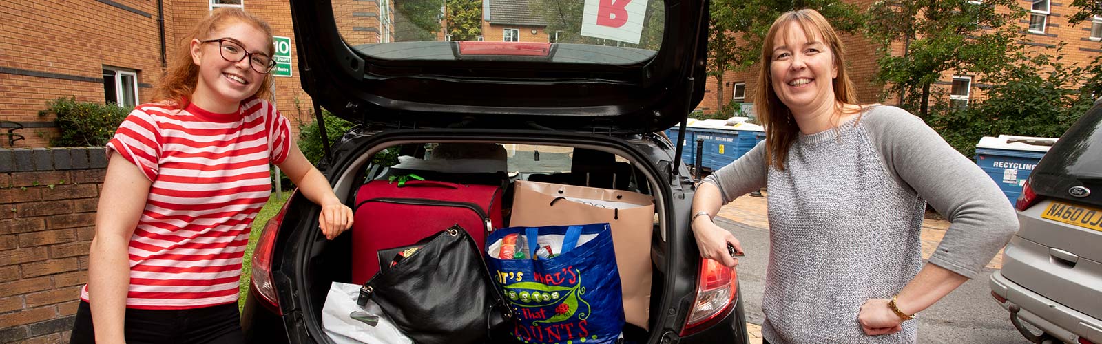 Mother and daughter at the car on moving day