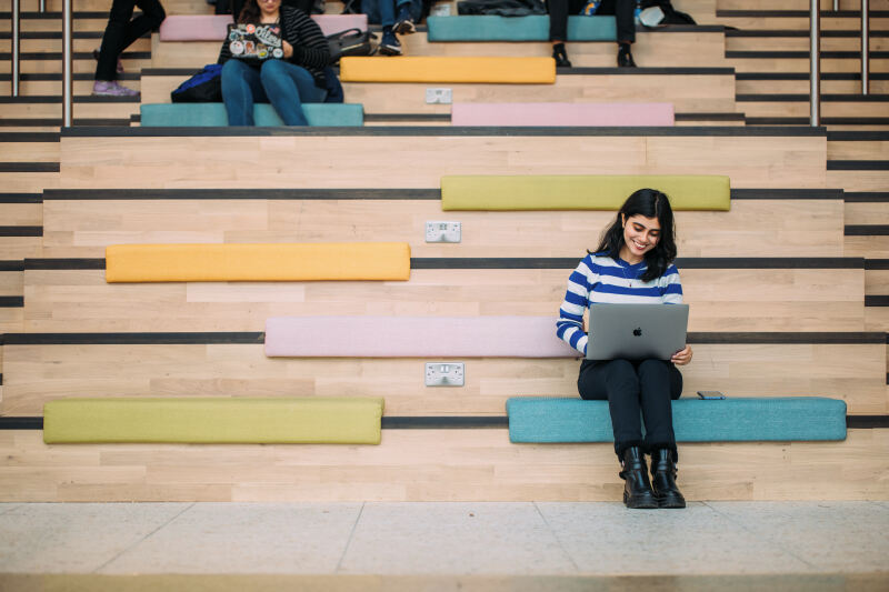 Student on laptop in One Elmwood building