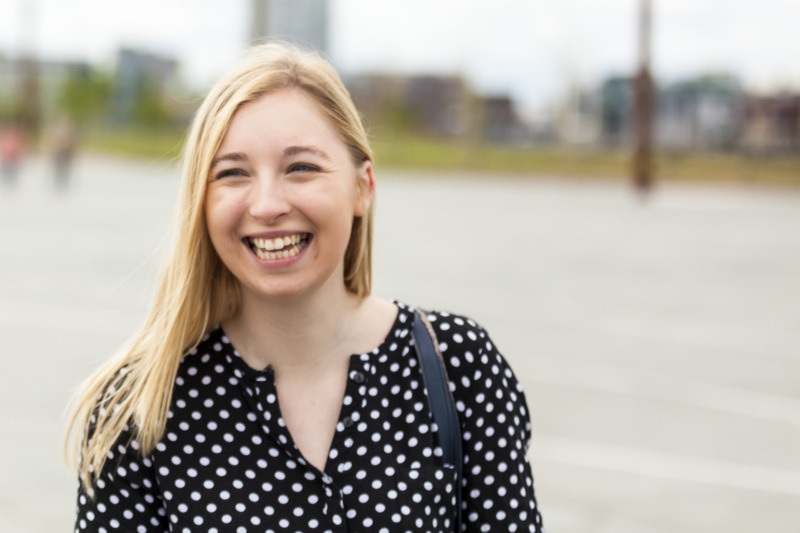 female student smiling with titanic museum in background