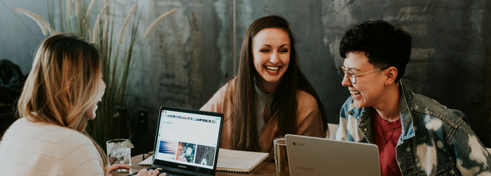 students laughing in coffee shop 1600x575