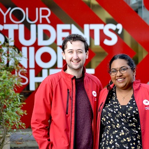 Two officers from the Students' Union laugh in a candid shot