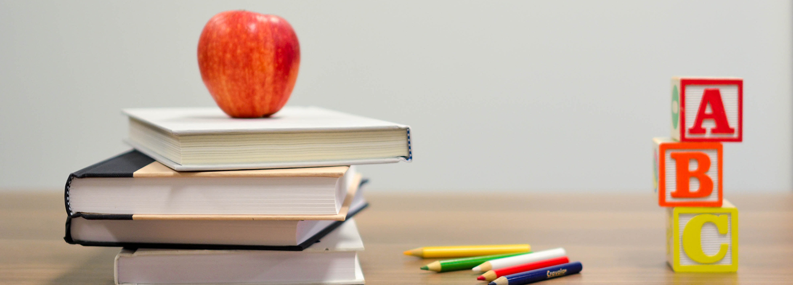 Stacked books, an apple, blocks