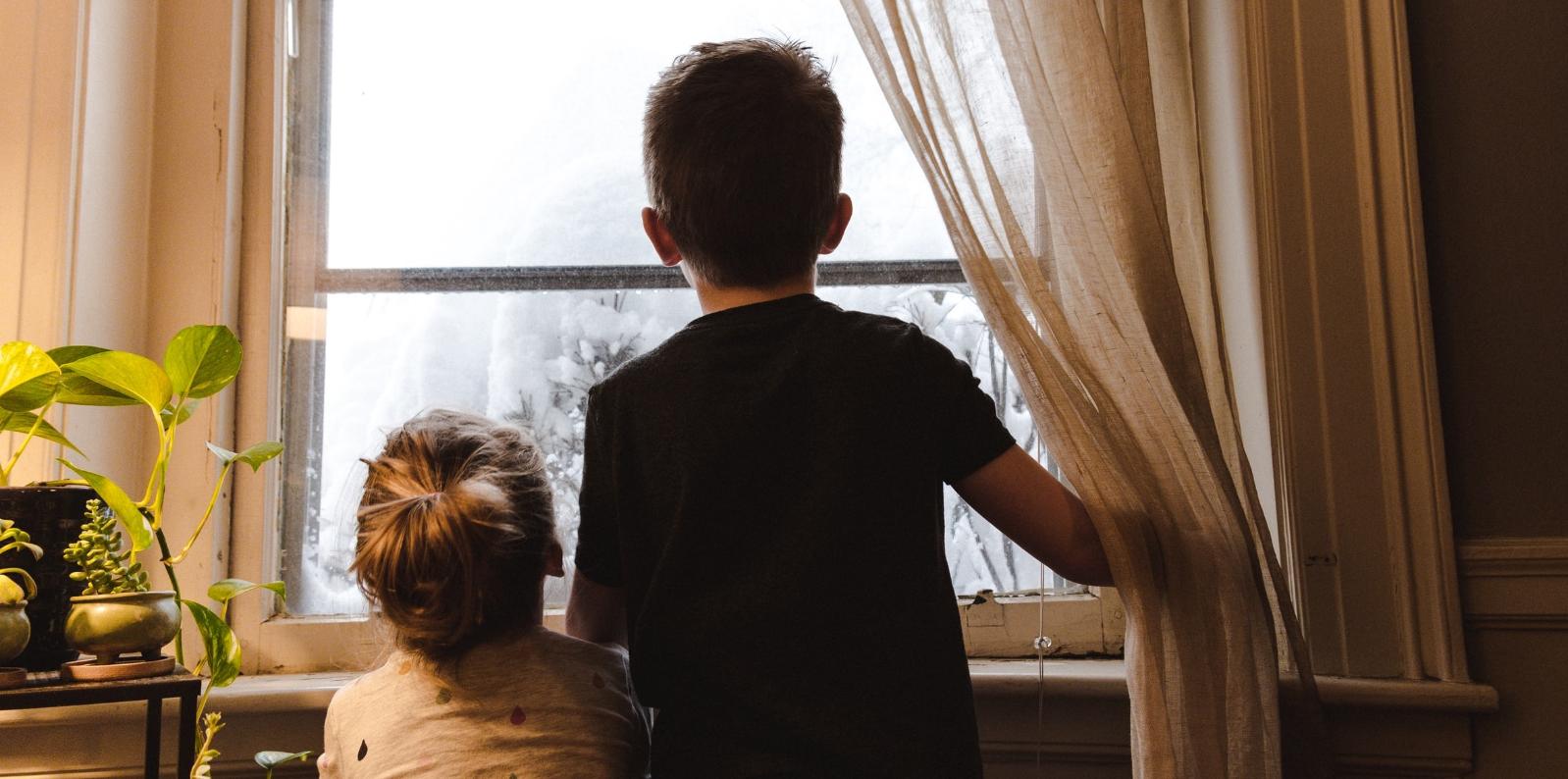 Children looking out a window