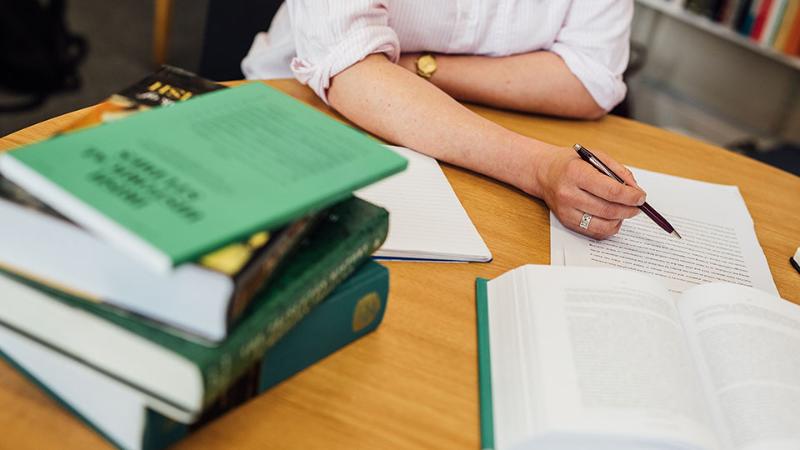 Supervisor, student and a pile of books