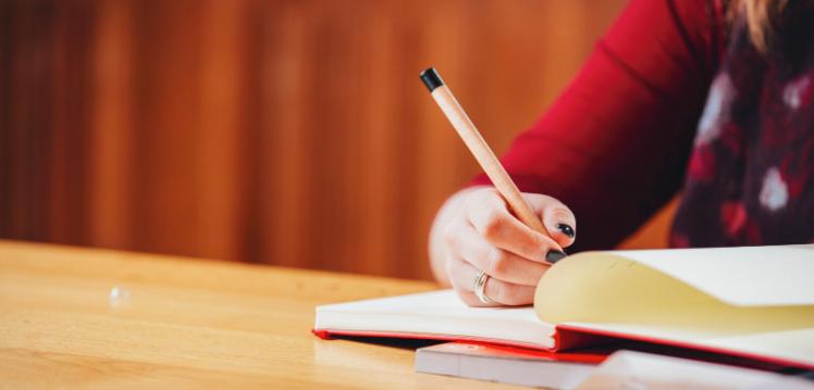 Student writing in notebook