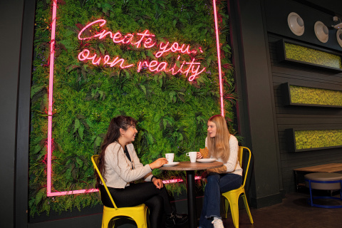 Two students having coffee in accommodation social space