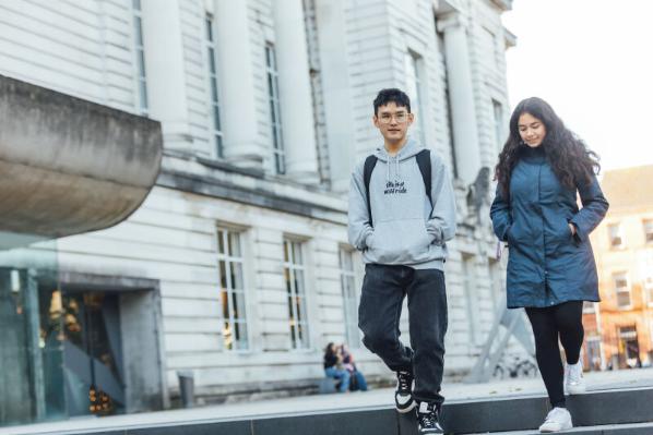 Students Bryan and Diana walking past Ulster Museum