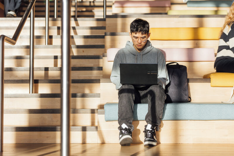 Student Bryan on laptop on One Elmwood