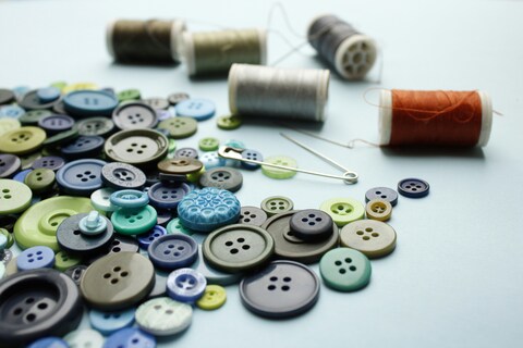 Collection of buttons, threads and needles