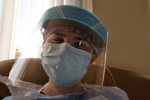 Medicine student Callista in mask and scrubs