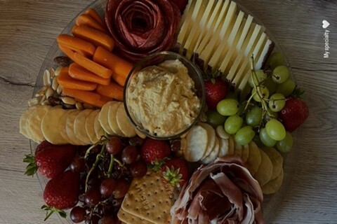 Cheese board with crackers and fruit