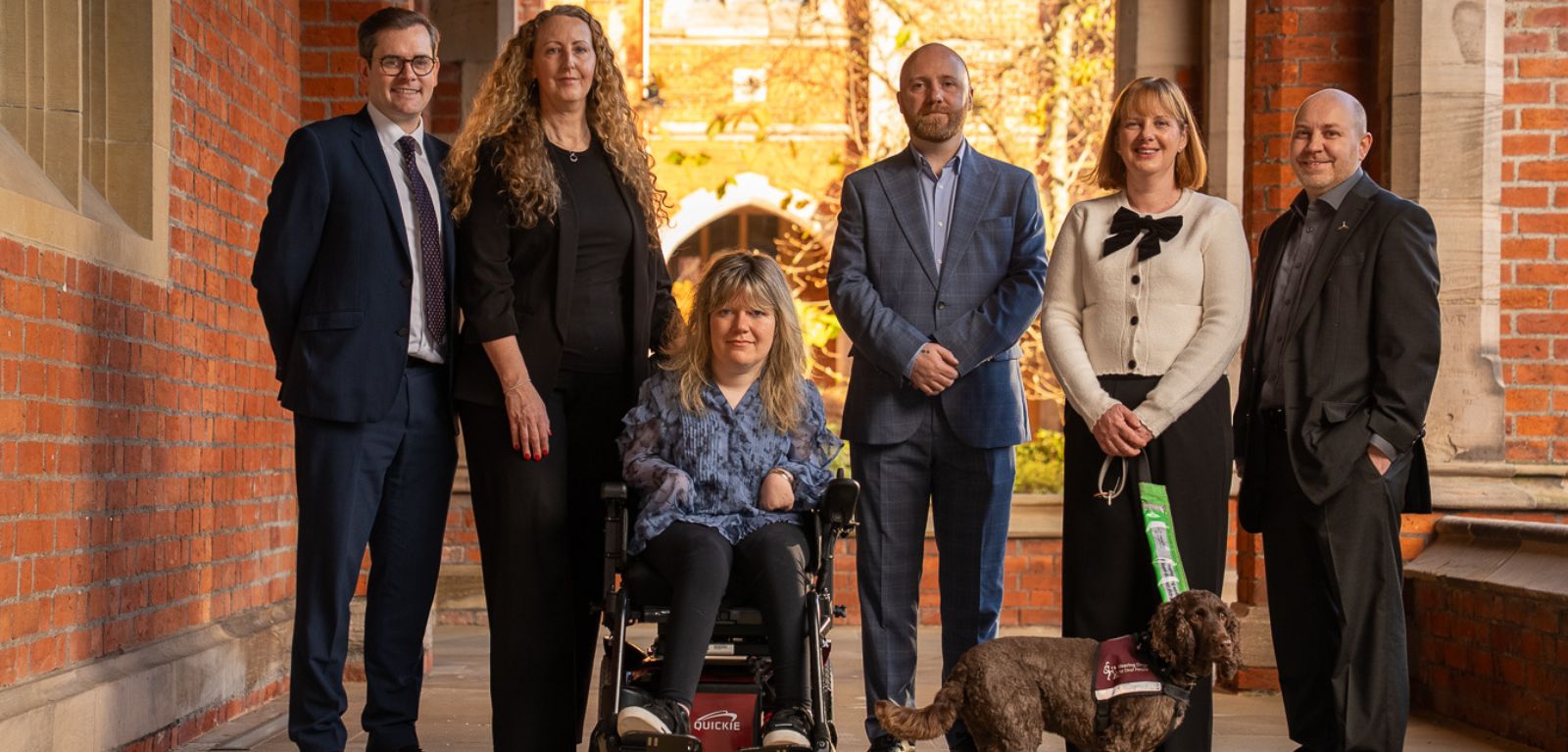 Group of people in a row under the cloisters at Queen's University Belfast