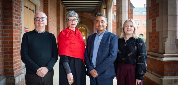 Row of people standing under the cloisters at Queen's