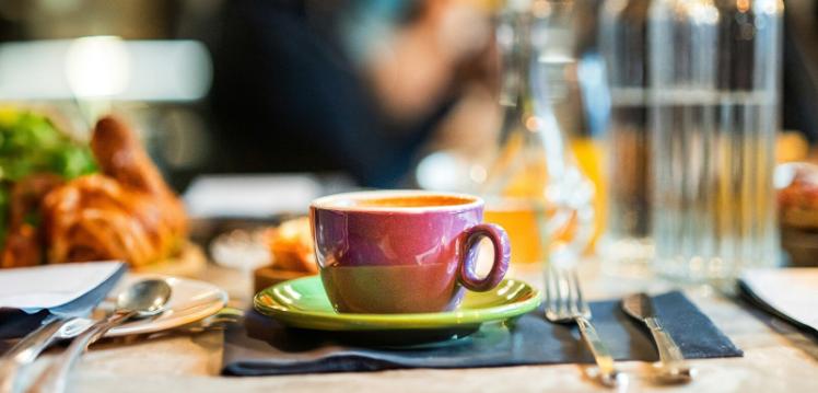 Cup and saucer on table