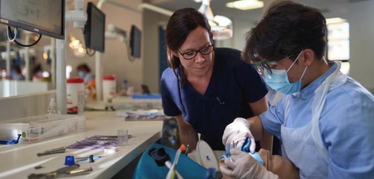 Dentistry student being mentored by female staff member