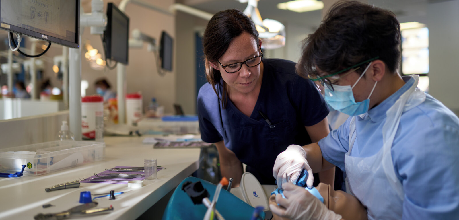 Dentistry student being mentored by female staff member