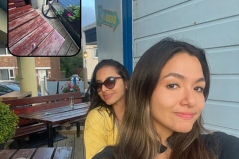 Two students sitting outside Dirty Duck Alehouse