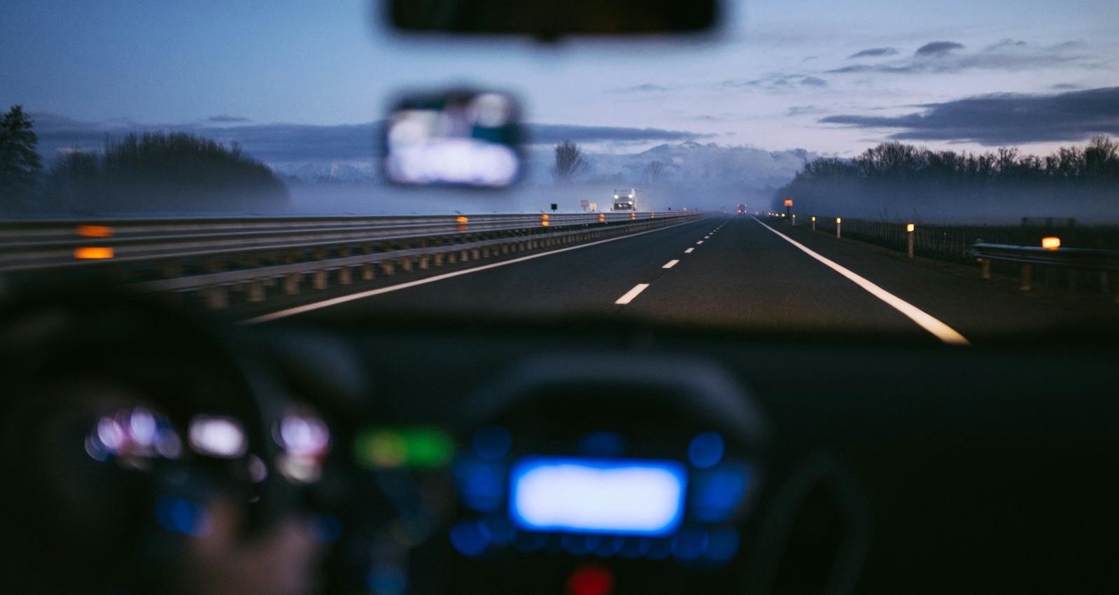 Driving down a road in the evening