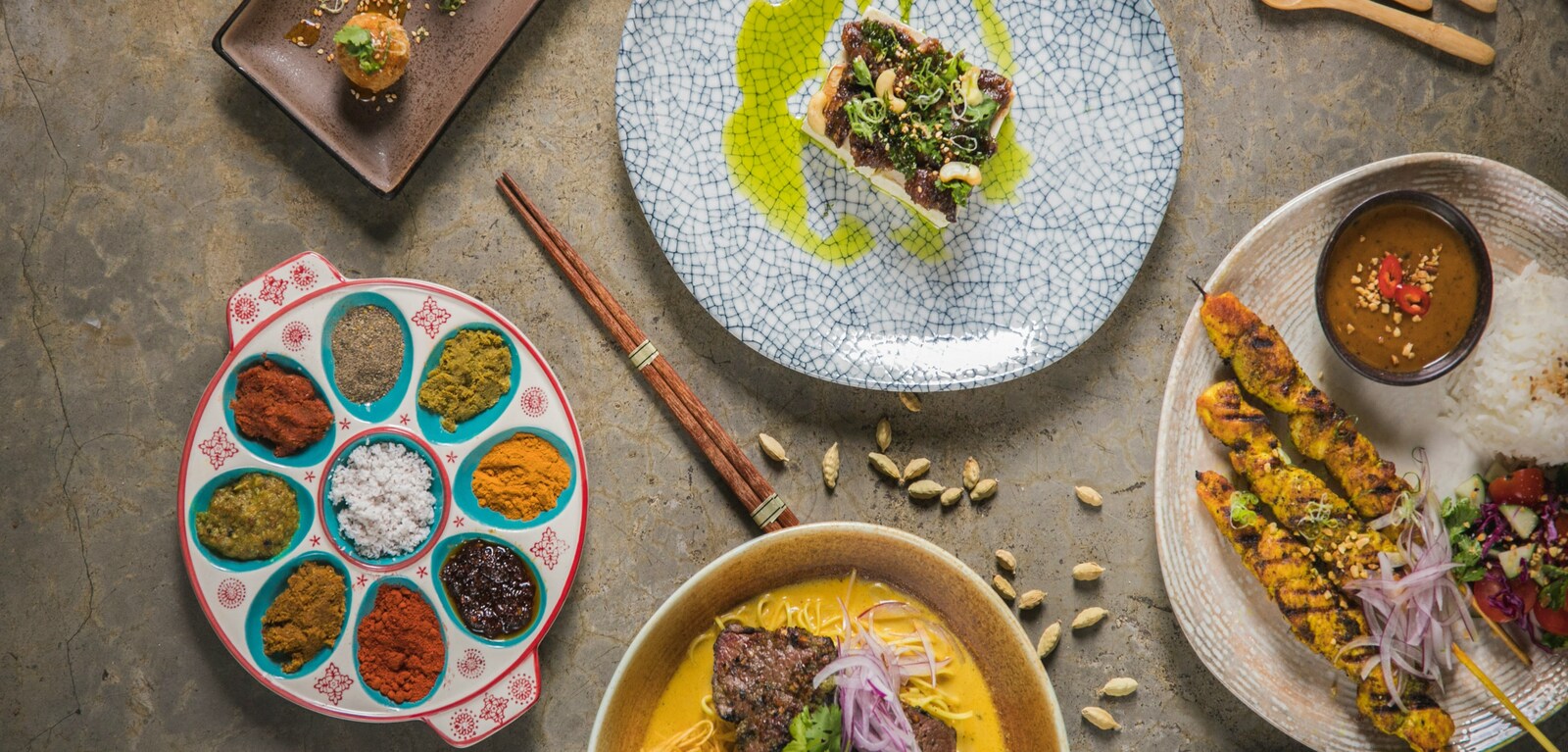 Plates of Indian dishes on a table