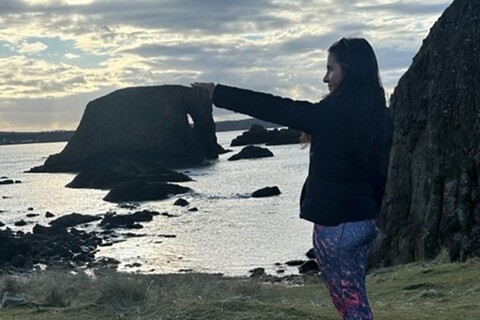 Student at elephant rock formation in Ballintoy Harbour