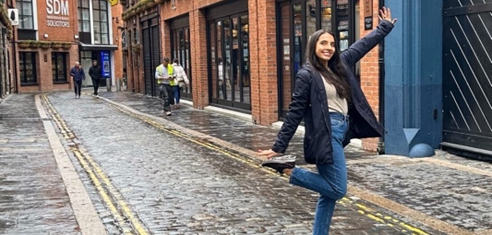 Student posing beside the Harp Bar in the Cathedral Quarter