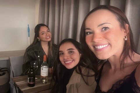 Student Isa having drinks at home with two female friends