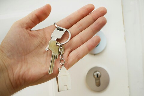 Person holding keys to a new house