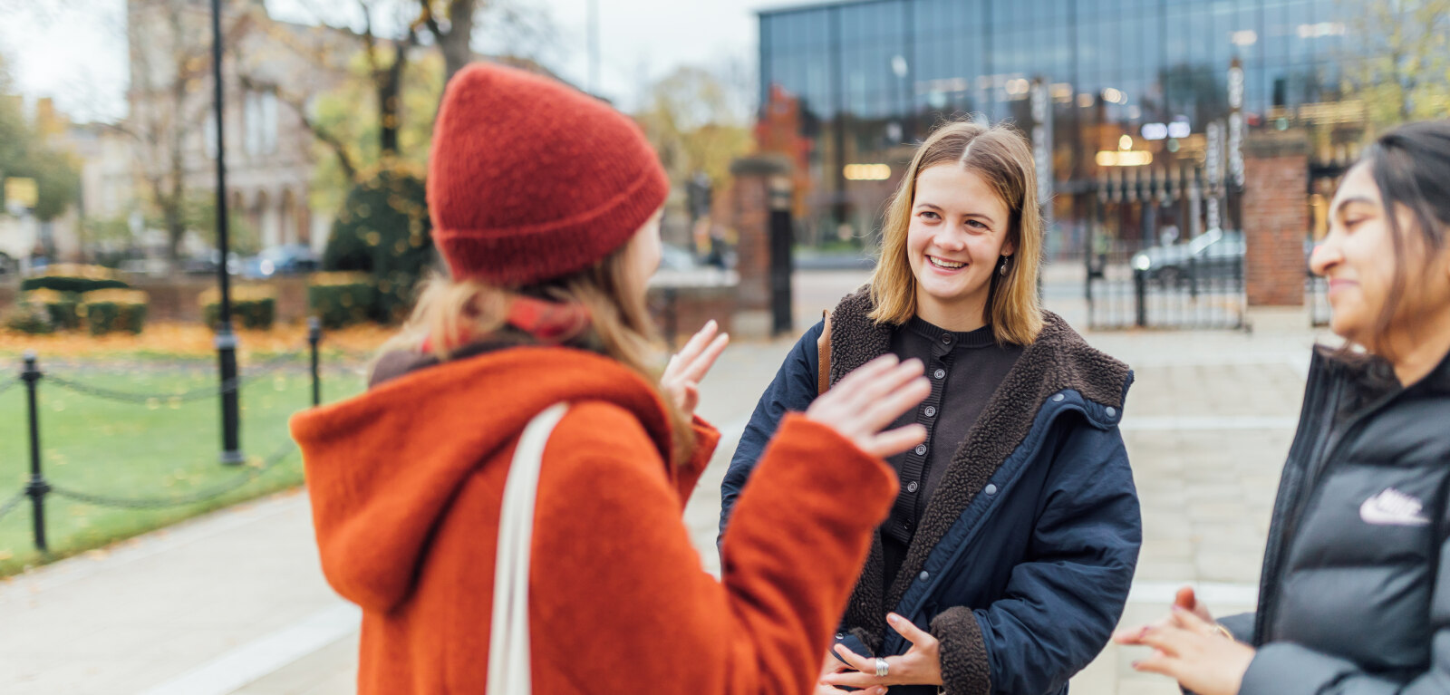 Three female students talking outside the Lanyon
