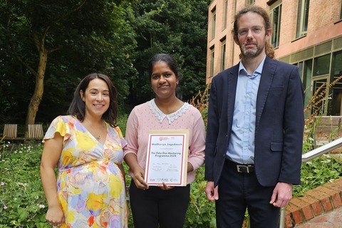 Student Madhurya receiving certificate from QBS staff